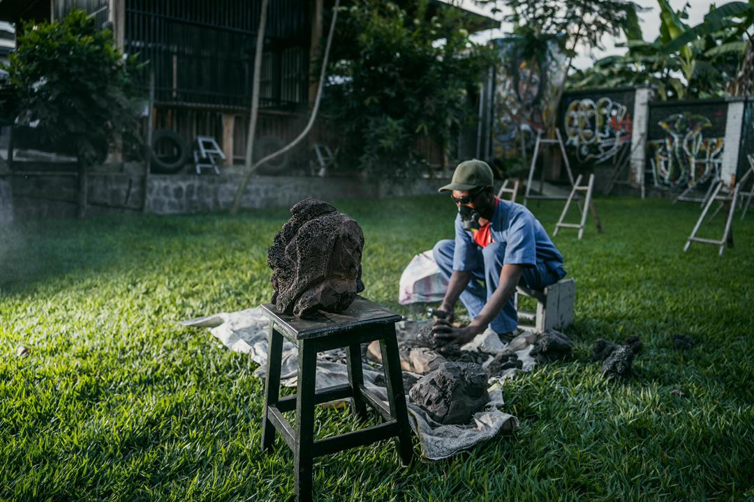 Carving a lava-stone gorilla sculpture